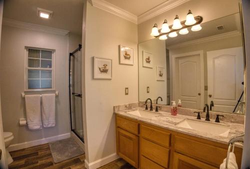 a bathroom with a sink and a large mirror at Home away from Home in Lake City