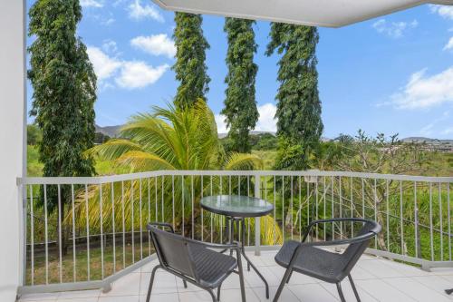 a patio with two chairs and a table on a balcony at Trans International Hotel in Nadi