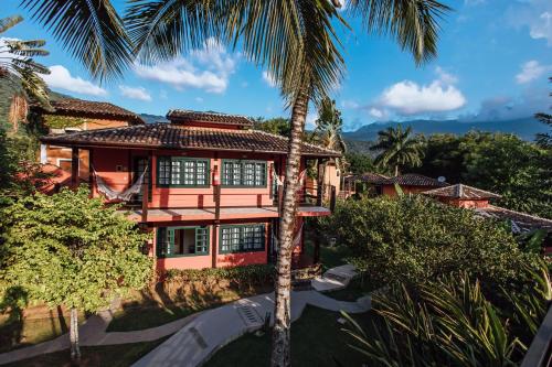 an aerial view of a house with palm trees at Pousada Vila das Pedras in Ilhabela