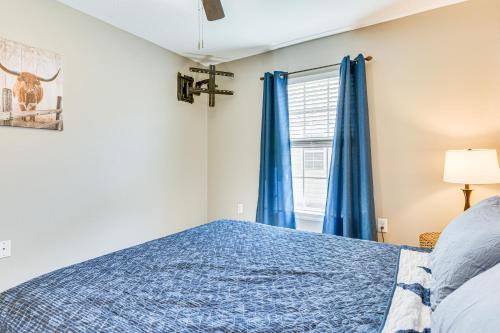 a bedroom with a blue bed and a window at Outdoor Entertaining Space Family Home in Milton in Milton