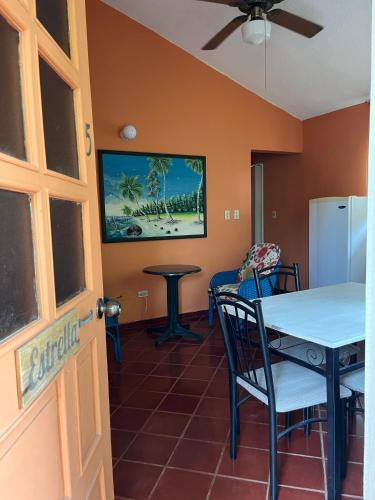 a dining room with a table and a refrigerator at PLAYA BLANCA BED AND BREAKFAST in Bayahibe