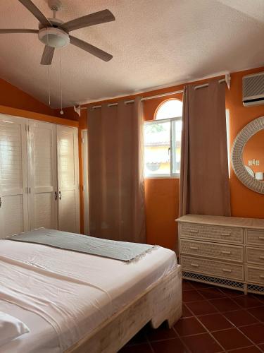 a bedroom with a bed and a ceiling fan at PLAYA BLANCA BED AND BREAKFAST in Bayahibe