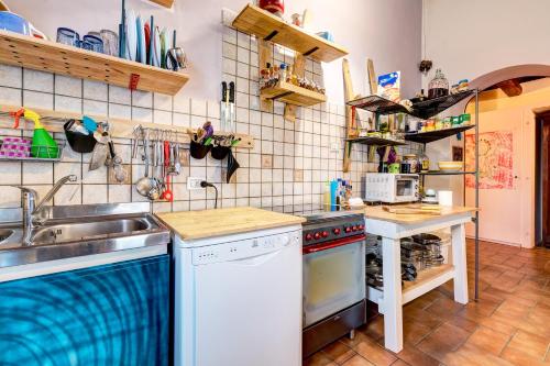 a kitchen with a sink and a stove at Back Home in Pienza