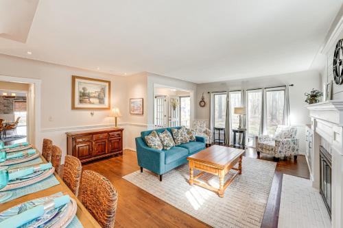 a living room with a blue couch and a table at 3 Mi to Duck Lake State Park Home with Deck! in Muskegon