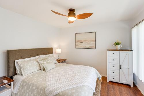 a bedroom with a bed with a ceiling fan at 3 Mi to Duck Lake State Park Home with Deck! in Muskegon