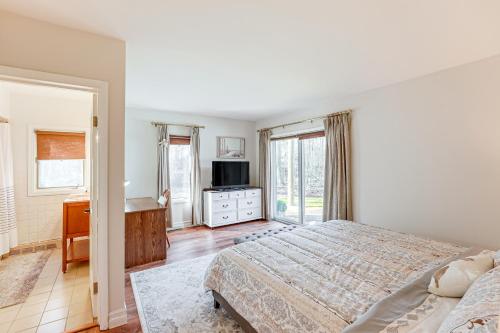 a bedroom with a bed and a desk and window at 3 Mi to Duck Lake State Park Home with Deck! in Muskegon