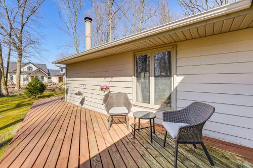 two chairs and a table on a wooden deck at 3 Mi to Duck Lake State Park Home with Deck! in Muskegon