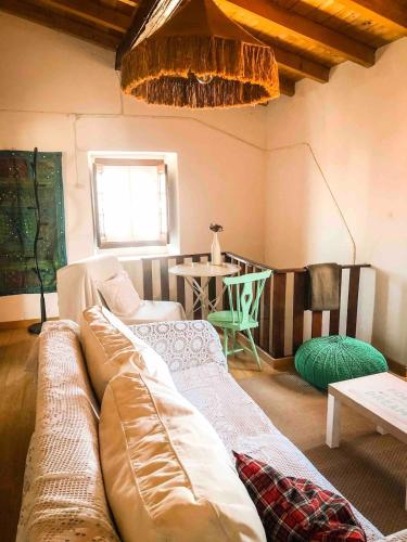 a living room with a couch and a table at Casa do Lado in Reguengo