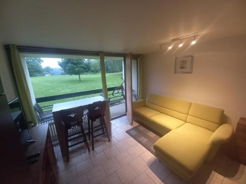 a living room with a couch and a table at Ap76 Nature Ardennes Economy class apartment in La Calamine