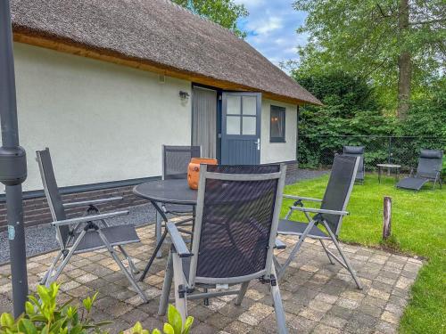 a table and chairs in front of a house at Villa Brocante in Alphen