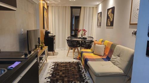 a living room with a couch and a table at Luxury Paiva Flat in Recife