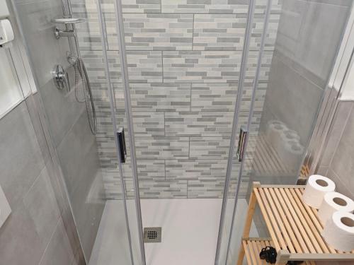 a shower with a glass door in a bathroom at A casa di Vito in Matera