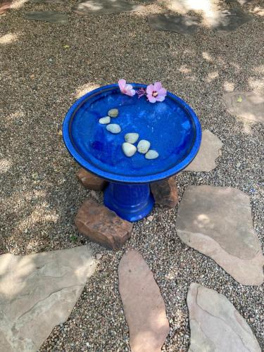 a blue table with rocks and flowers on it at Casa de Tres Lunas/House of Three Moons in Santa Fe
