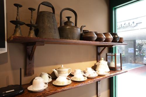 a shelf filled with pots and pans on a wall at Maron Hotel Nampo in Busan