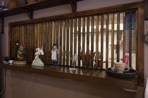 a wooden shelf with figurines on top of it at Maron Hotel Nampo in Busan