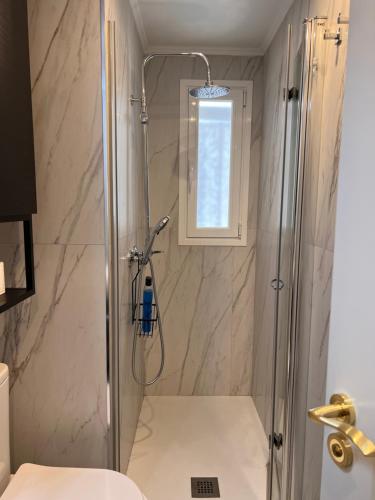 a shower with a glass door in a bathroom at Room SestoA in Madrid