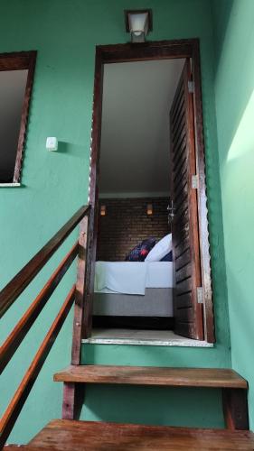a view of a room with a bed and a staircase at Pousada Preguiça in Canoa Quebrada
