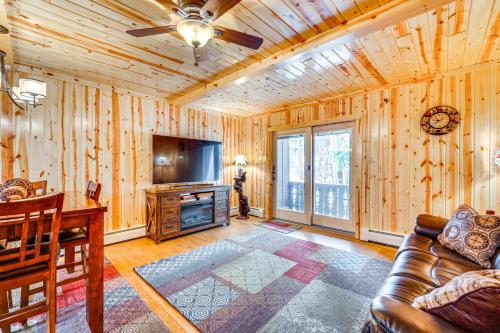 a living room with a couch and a flat screen tv at 1 Mi to Rocky Mtn Natl Park Estes Park Townhome in Estes Park