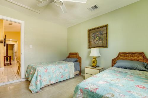 a bedroom with two beds and a lamp at Mins to the Coast Port St Lucie Home with Lanai! in Fort Pierce