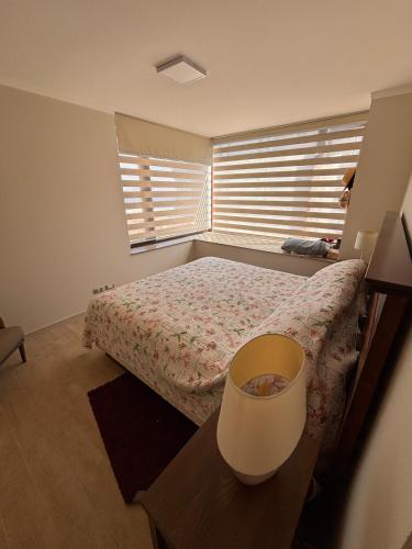 a small bedroom with a bed and a window at Apartment in Quintay in Quintay