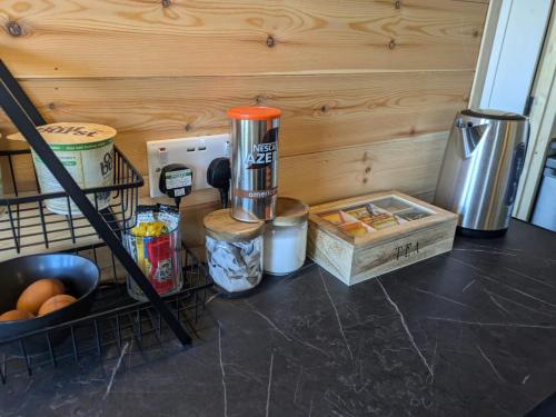 a kitchen counter with food items on a table at The Homestead Compact With private Lazy spa in Northbourne