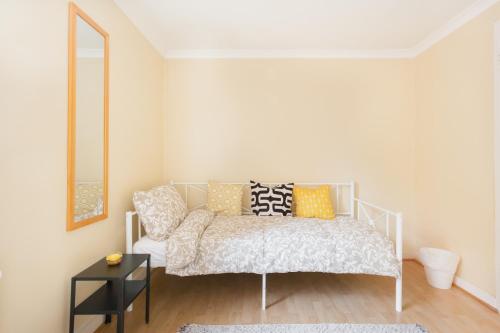 a bedroom with a bed with pillows and a mirror at Tower Bridge Home in London