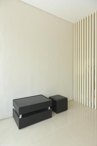 two black boxes sitting on the floor in a room at GreenLake Vista in Surabaya