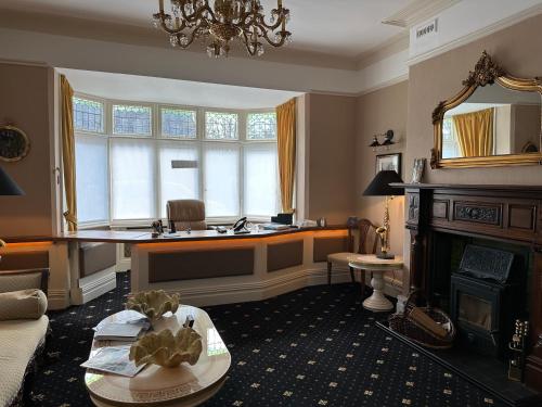 a living room with a large window and a table at Chester House Guest House in Chester