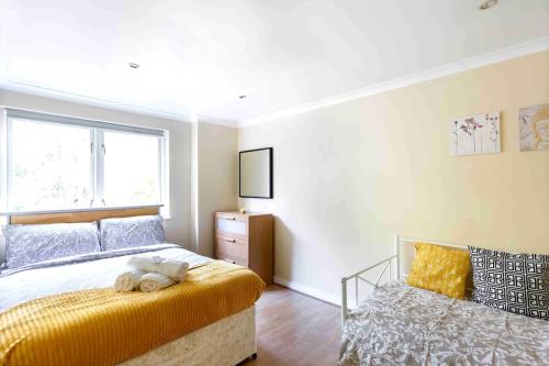 a bedroom with a bed with a teddy bear on it at Tower Bridge Home in London