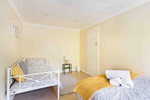 a white bedroom with a bed and a chair at Tower Bridge Home in London