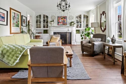 a living room with a couch and chairs and a fireplace at Historic Downtown Berlin Home Dog Friendly Home in Berlin