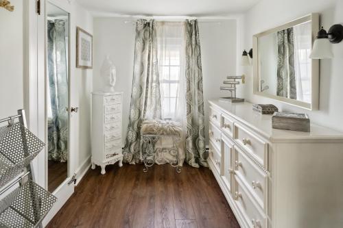 a white room with a chair and a window at Historic Downtown Berlin Home Dog Friendly Home in Berlin