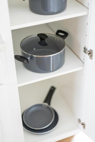 a pot and pan on a shelf in a kitchen at Luxury Downtown Townhome Private Garage Unit 4 in Cleveland