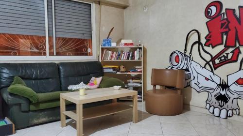 a living room with a green couch and a table at SK Homestay in Casablanca