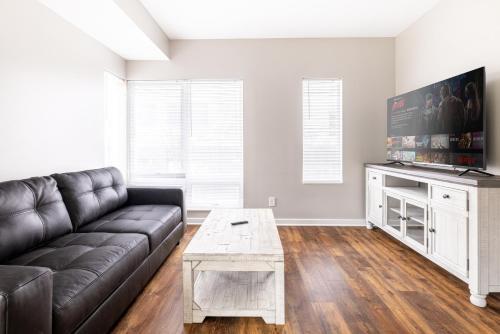 a living room with a couch and a tv at Luxury Downtown Townhome Private Garage Unit 11 in Cleveland