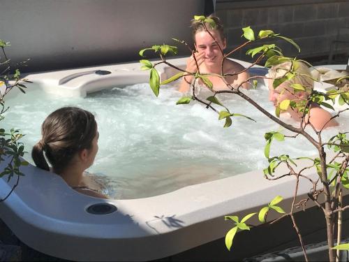 a woman is in a jacuzzi bathtub at Aalen in Jindabyne