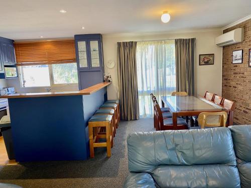 a living room with a bar and a table at Aalen in Jindabyne
