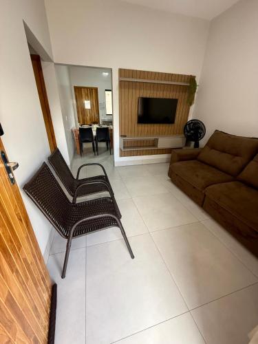a living room with a couch and a table at Condomínio Bela Vista - Casa 11B in Campo Novo do Parecis