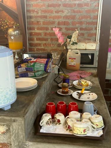 a table with plates of food and red cups at MyDusun Chalet, Taiping, Perak, Malaysia in Taiping