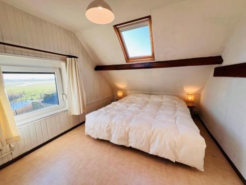 a bedroom with a white bed and a window at Holiday Home in Wenduine near Zeedijk in Wenduine