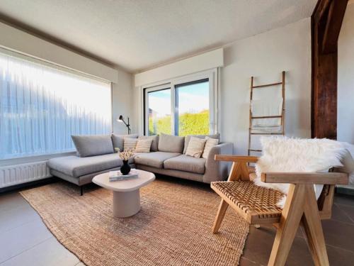 a living room with a couch and a table at Holiday Home in Wenduine near Zeedijk in Wenduine