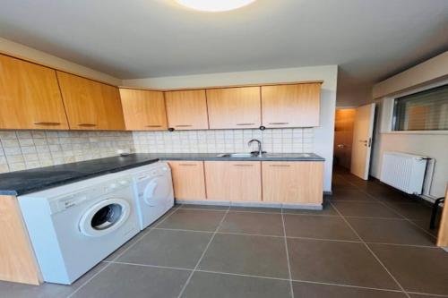 a kitchen with a washing machine in a kitchen at Holiday Home in Wenduine near Zeedijk in Wenduine