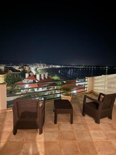 a balcony with chairs and a view of a city at Beach Views-Ocean Breeze-Duplex Dreams in São Martinho do Porto