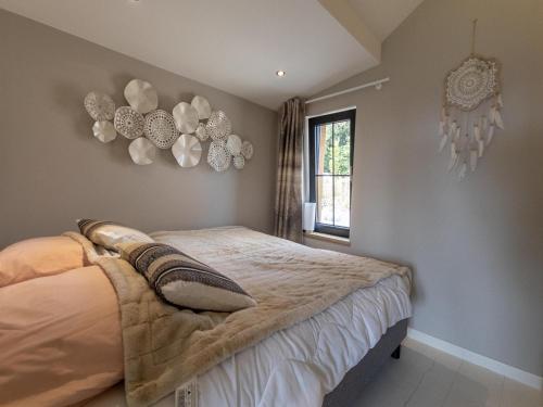 a bedroom with a bed and some decorations on the wall at Chalet in Trois-Ponts near Coo Waterfalls in Trois-Ponts