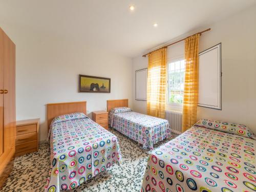 a bedroom with two beds and a window at Villa in L Escala near Riells Beach in L'Escala