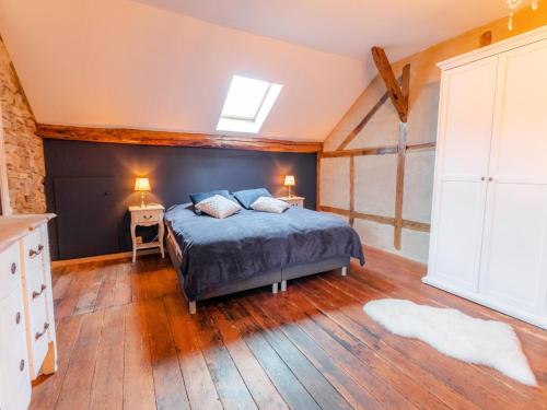 a bedroom with a bed and a skylight at Country House near Coo Waterfalls with Jacuzzi in Stoumont