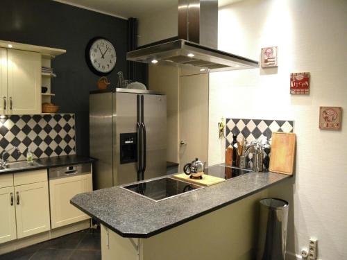 a kitchen with a sink and a refrigerator at Villa in Vielsalm with Lake Views and Pool in Vielsalm