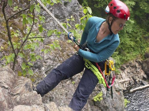 a woman in a helmet climbing on a rock wall at Villa in Vielsalm with Lake Views and Pool in Vielsalm