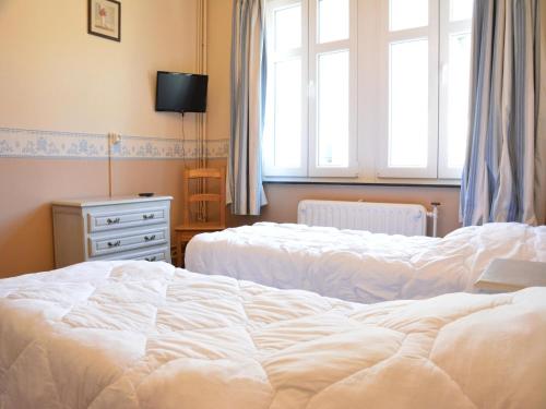 a bedroom with two white beds and a window at Villa in Vielsalm with Lake Views and Pool in Vielsalm