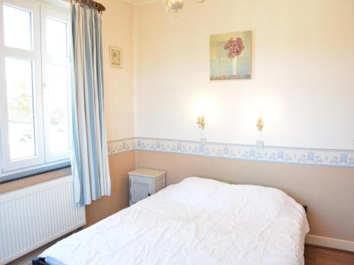 a bedroom with a bed and a window at Villa in Vielsalm with Lake Views and Pool in Vielsalm